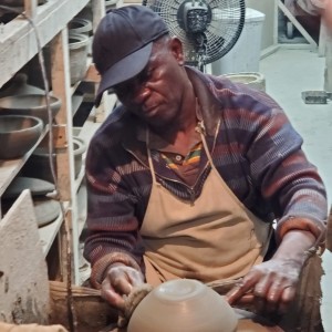 A potter making a pot on a potter
