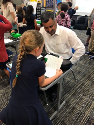 principal Dr Bipul Singh with a school kid
