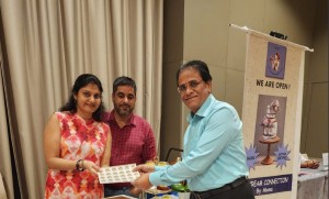 Mrs Mona of Cream Connections receiving the Sattvik certified Stickers from Venkat Kumar, SCSG