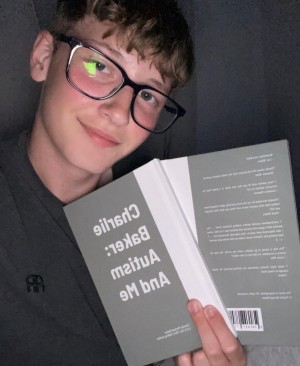 Charlie Michael Baker Holding Book Credit: Daily Mail 