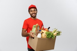delivery concept handsome african american delivery man carrying package box grocery food drink from