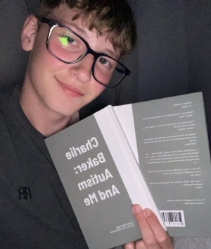 Charlie Michael Baker clutching his first published book
