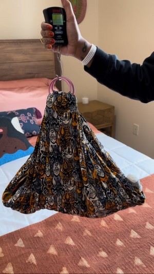 Midwife Racha Tahani checking a baby’s weight postpartum