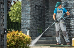 Pressure washing technician cleaning a home sidewalk