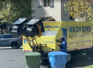 Trash can cleaning service steam cleaning a trash can