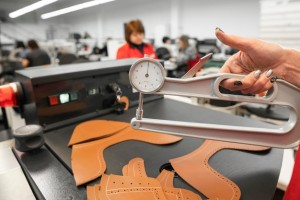 woman hands use leather thickness gauge with natural brown leather 758740 1487