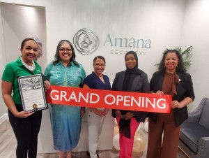 Council Member Clouser, (left) holds proclamation at business grand opening