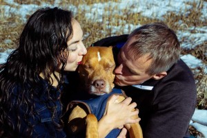 Husband and wife taking pics with their beloved dog