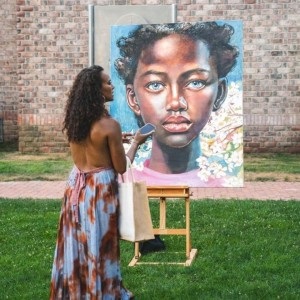 VIP guest admiring artwork during the outdoor art exhibition