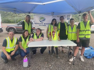 Volunteers and Staff support Mending Minds Village booth June 7, 2024