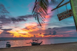 Beach with boats and local sign