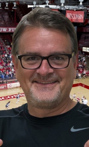 Smiling James Seidel in black Nike t shirt at basketball court