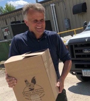 Volunteers work to distribute eggs to Iowans in need during the company