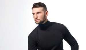 A man in black wearing a thin skin hair system with bleached knots