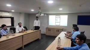 Chiman Maru leading a project discussion in the conference room, guiding his team to success.