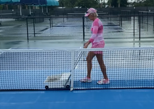 Terri Wirth of the Pickleball Breakfast Club dries the courts.