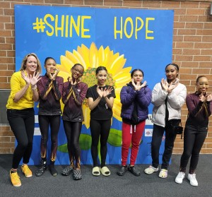 Kathryn Goetzke with the Chicago Contemporary Dance group, taking photos at the Shine Hope mural.