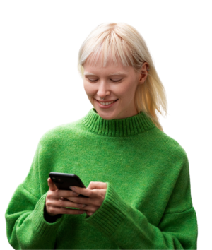 Woman smiles, using her phone