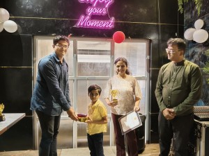 Sarthak receiving trophy and certificate