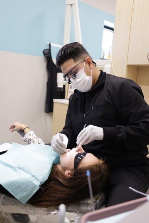 Dental hygienist with dental implants patient at True Dental Group Independence