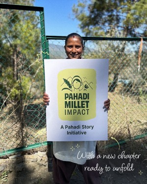 The Pahadi Story women associate holding Pahadi Millet Impact placard