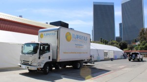 large 30 feet by 120 feet tent rental setup by school entrance in 2023