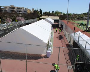 Spacious 30x90ft tent setup in the tennis court area for merchandise pickup during the 2022 Student