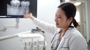 Alexandria dentist Dr Irene Shin explaining root canal procedure with dental patient at U Shine Dent