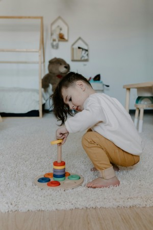 Child with autism at home, playing during in-home ABA therapy session.
