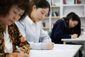 Shincheonji Church of Jesus members taking a practice test together ahead of the exam.