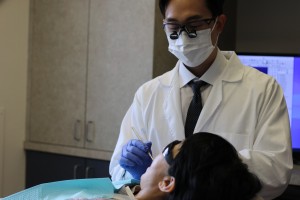 Cosmetic dentist Dr Harry Shin fitting porcelain veneers at Moritis Shin Dentistry of Seattle