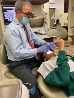 Concord dentist Dr Haidari performing dental implants procedure at Clayton Dental Group