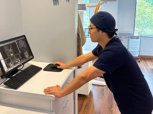 Germantown dentist Dr San Cho referring to digital x ray images for dental implants procedure at New