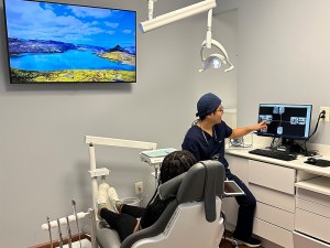 Germantown Dr Sang Cho explaining dental implants procedure to patient at New Life Dental