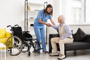long shot nurse helping old man getting up