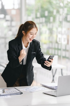 young businesswoman is excited about achieved sales target