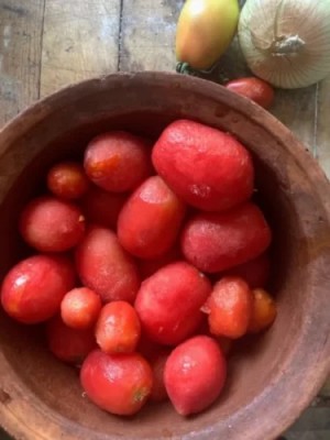 Tomatoes cooking in a clay pot
