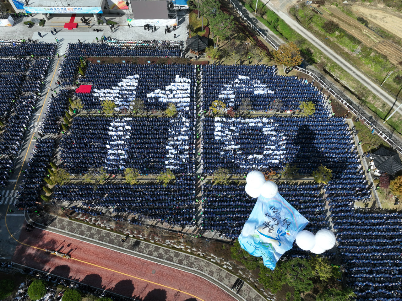 Graduates are seated outdoors during the 116th Graduation Ceremony of Zion Christian Mission Center