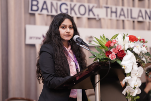 Leena Joshi delivering a keynote speech at a youth climate conference