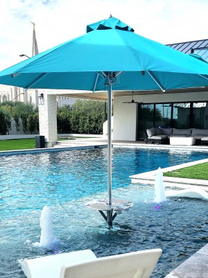 In-pool Bajamate luxury pool adapter, table and umbrella in high end pool with blue placemats