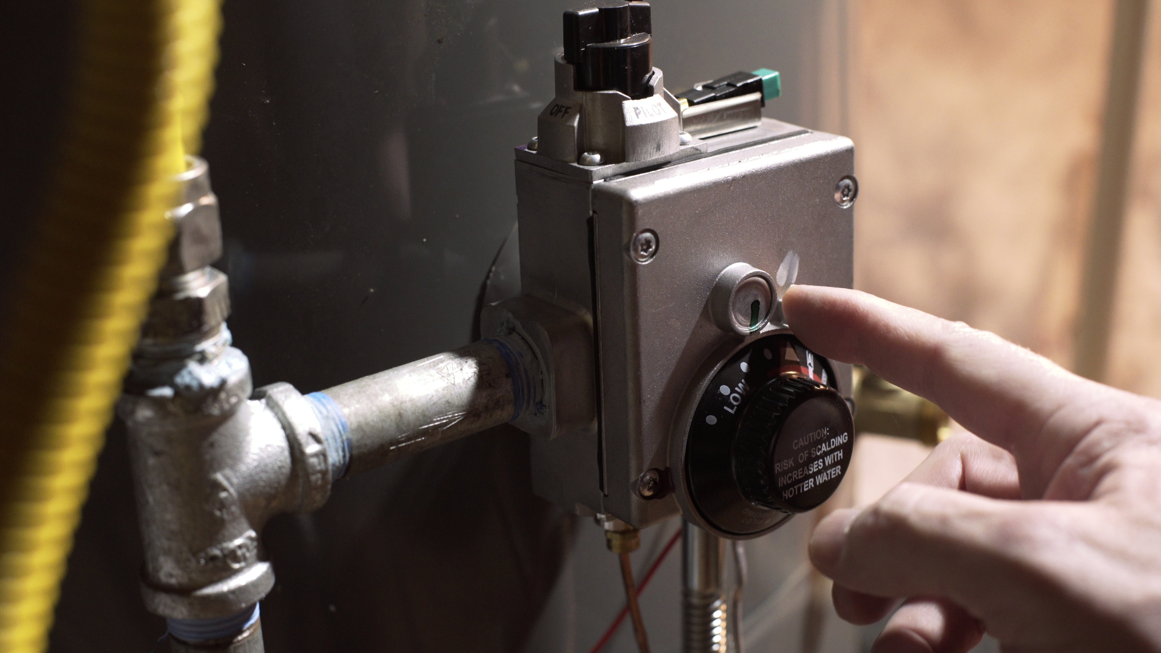 homeowner reducing the temperature of water heater 4k SBI 351412282 homeowner reducing the temperature of water heater 4k SBI 351412282