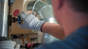 the serviceman diagnose the hvac system in the house on mechanical room SBI 349504667