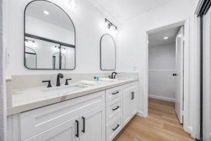 New bathroom featuring double vanity, modern fixtures, and upgraded finishes.