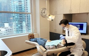 Seattle dentsit Dr Harry Shin performing dental implants procedure at Moritis Shin Dentistry of Seat