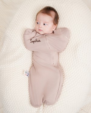 Temperature-regulating ClimaCuddle™ swaddle for all-season comfort.