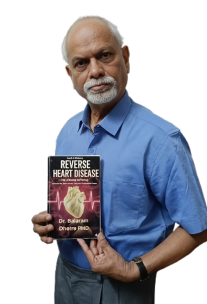 Dr Balaram Dhotre holding the book reverse heart disease no lifelonh suffering