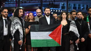 Filmmakers display a Palestinian flag on the Berlinale red carpet in protest