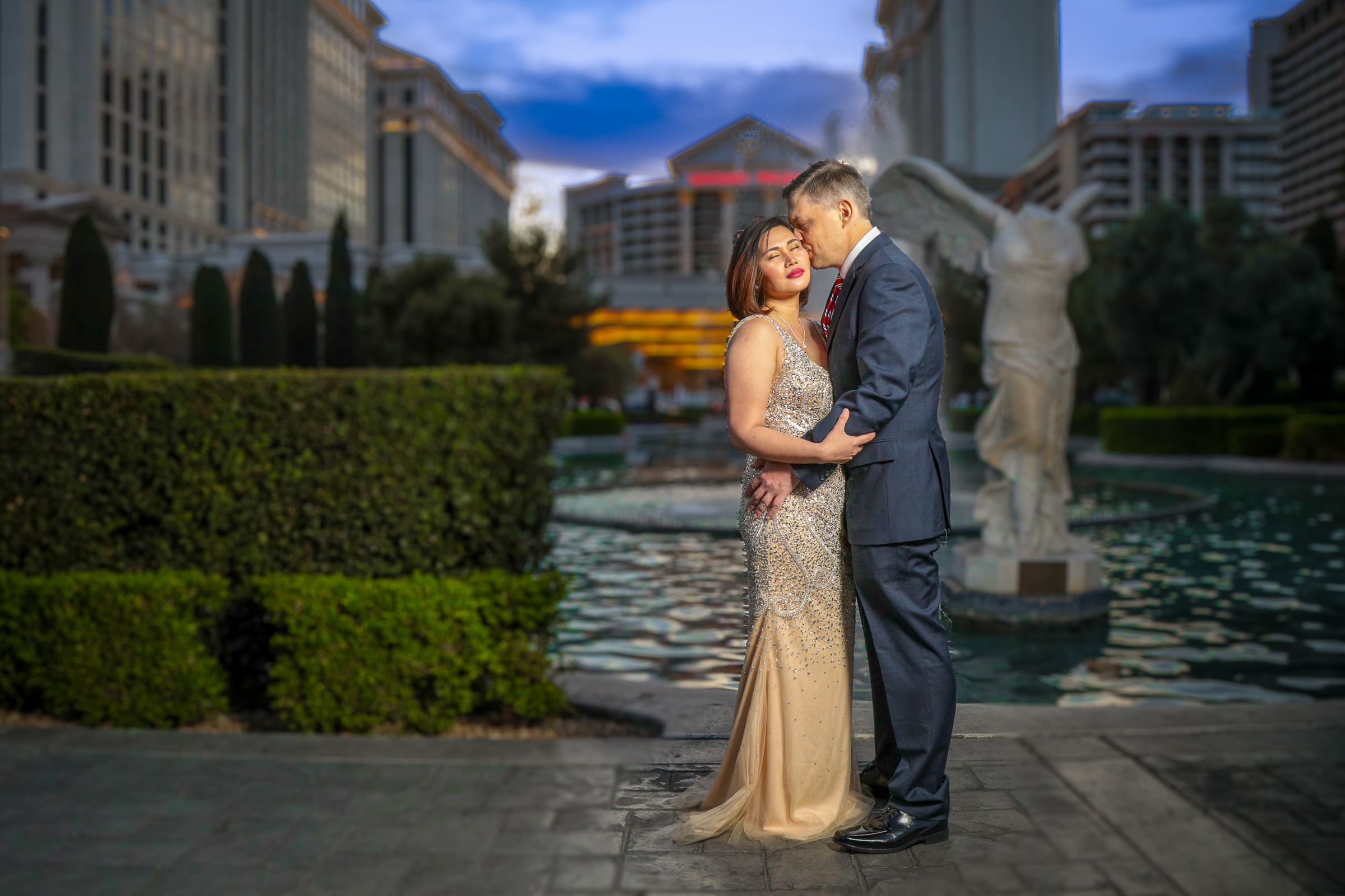 Elegant couple portrait with Las Vegas Strip and water feature backdrop