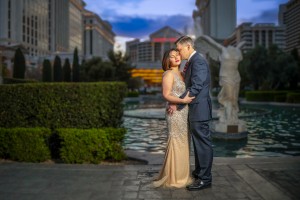 Elegant couple portrait with Las Vegas Strip and water feature backdrop