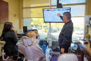 Dr Arthur Kwan reviewing digital diagnostics with a patient during a personalized treatment consulta